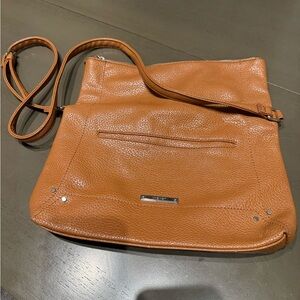 Tan leather crossbody bag with zipper closure and multiple pockets